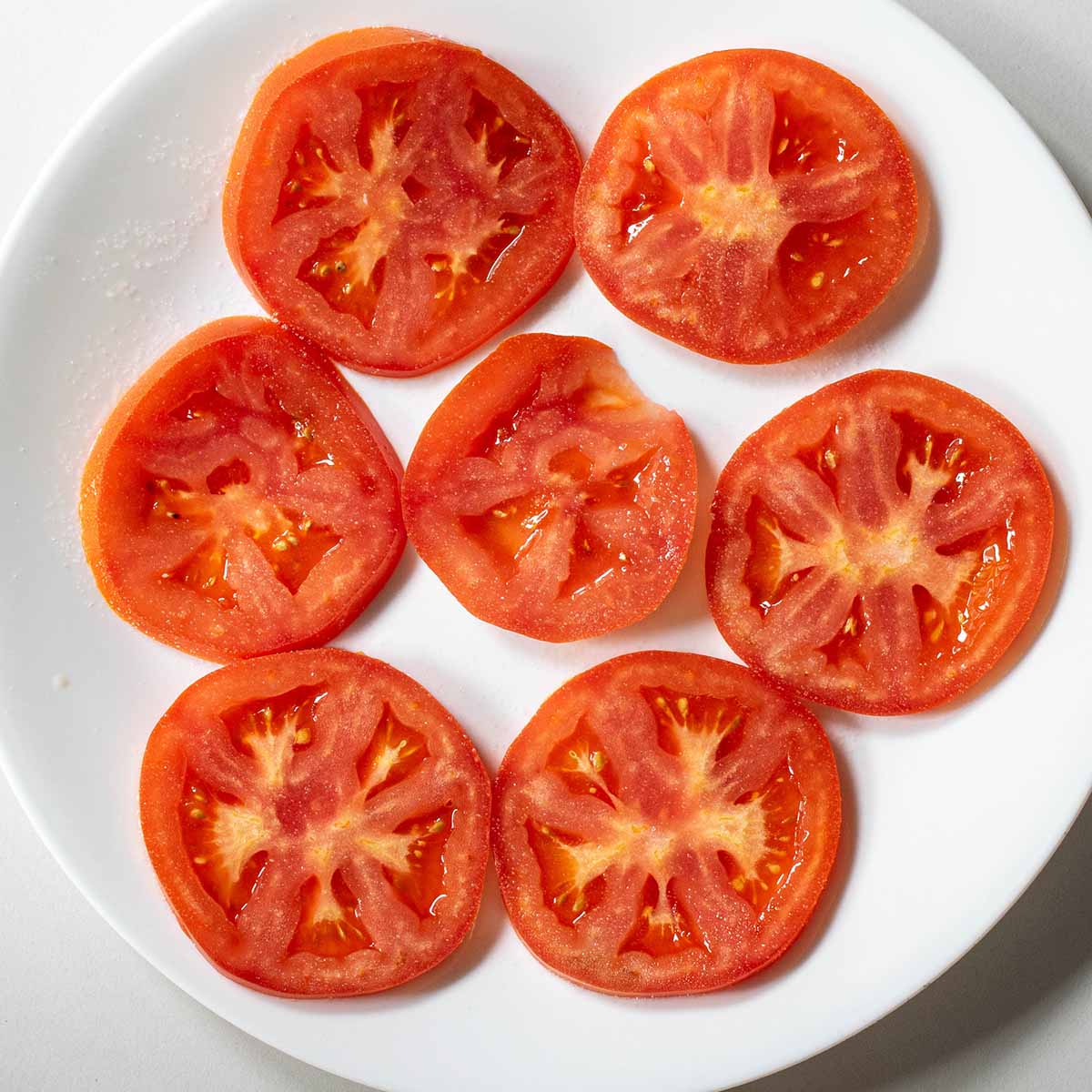 Beefsteak tomatoes sliced thin and salted to remove extra water so the sandwich bread doesn't get soggy.