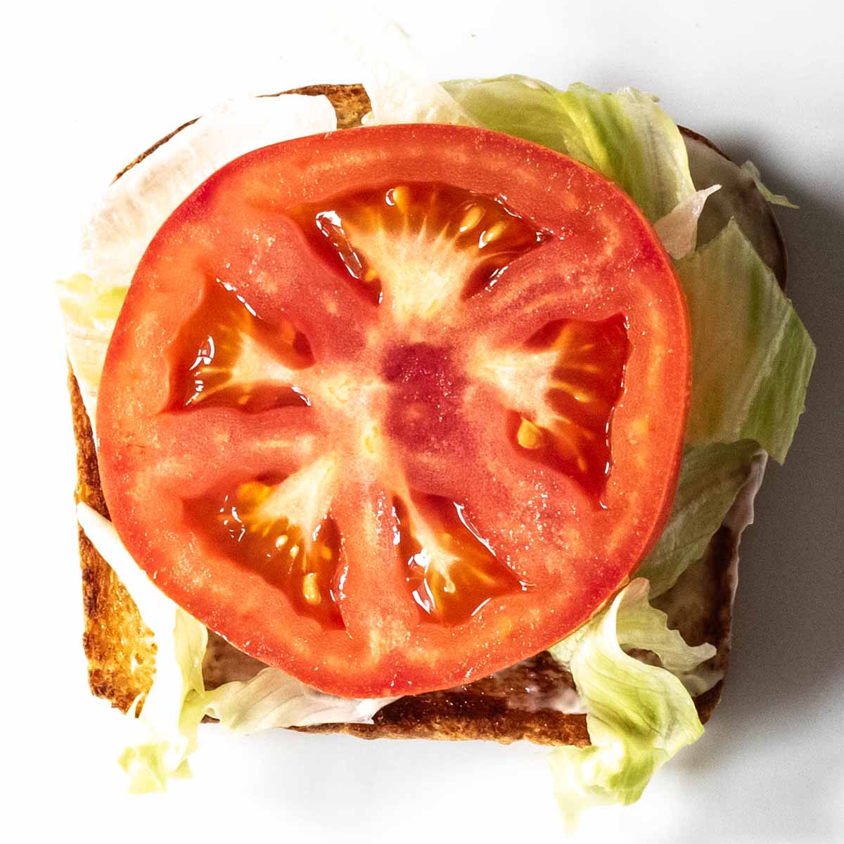Club sandwich layer 3: tomato.