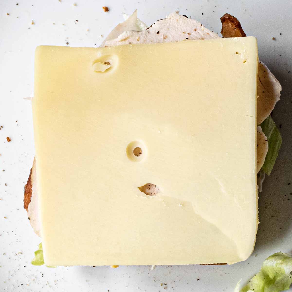 Club sandwich layer 6: cheese (optional).