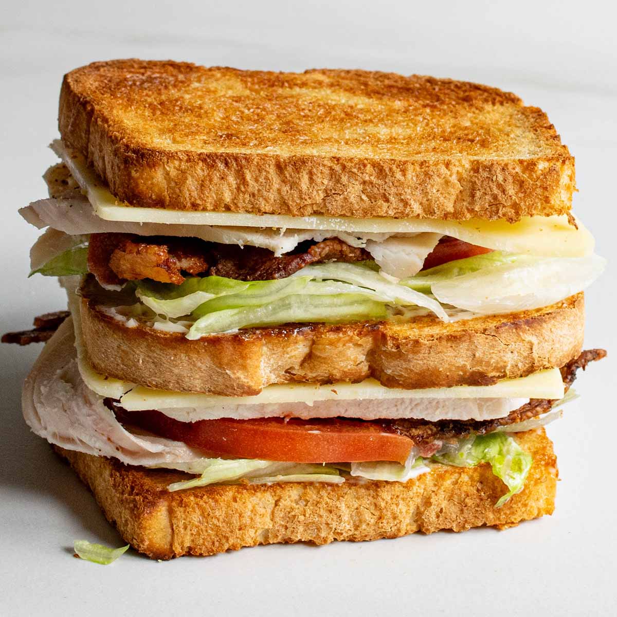 How to make and layer a club sandwich so ingredients don't slip out.