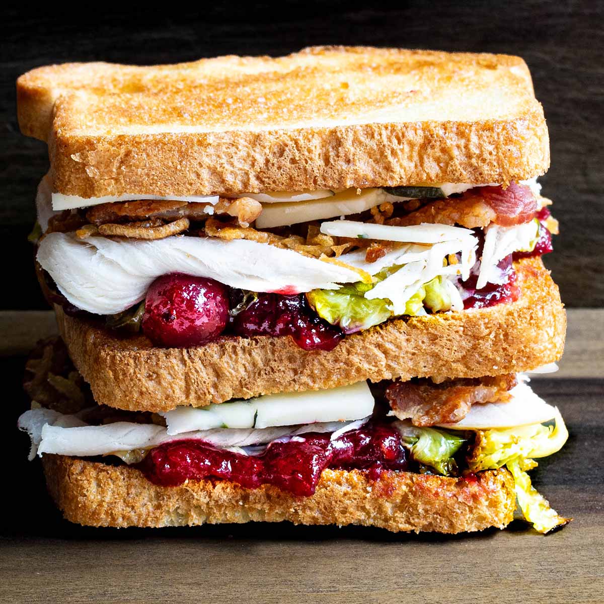 A sandwich made with Thanksgiving leftovers, stacked like a club sandwich.