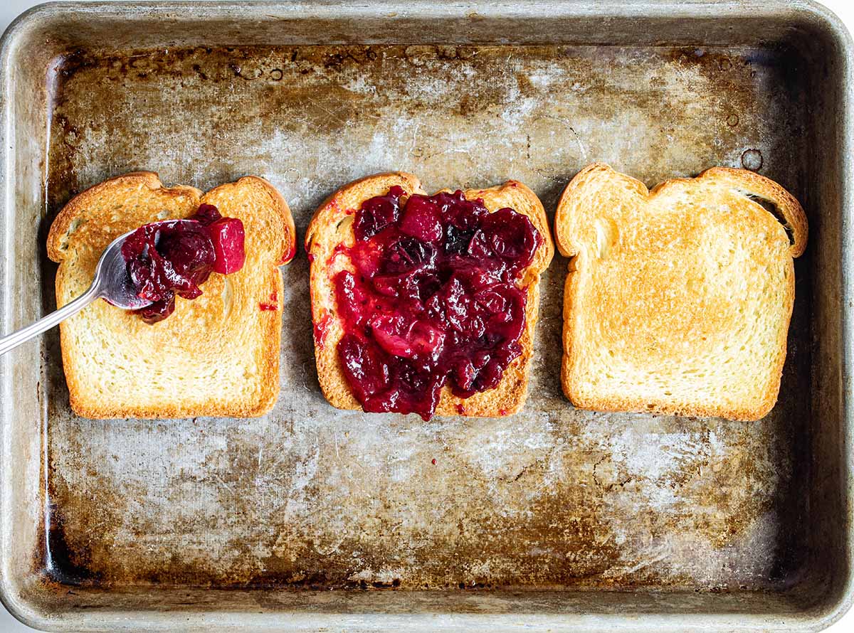 Leftover cranberry sauce from Thanksgiving, spread on sandwich bread.